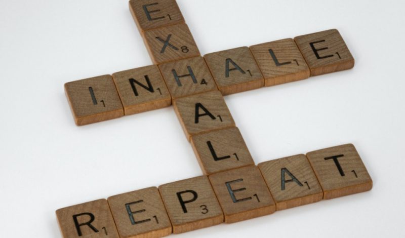 wooden scrabble that reads inhale, exhale, repeat